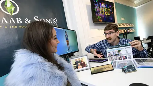 People sitting at a desk with a nameplate that says Geoffrey Landgraab