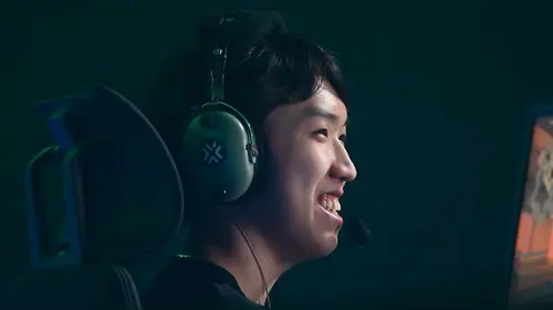 Bleed esports player sScary in side profile smiling on stage