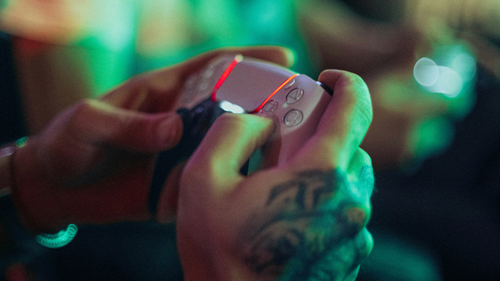 A PlayStation 5 DualSense controller glowing red.