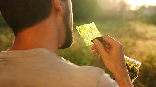 A man eating Annie Chun's Roasted Seaweed, a great gaming snack