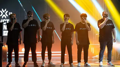 Bleed esports on stage, holding lower face masks up to their face