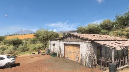 A barn with a motorway overpass in the distance.