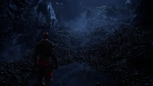 Red Hood looking at a pile of bones