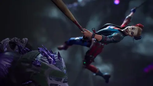 Harley Quinn hitting an alien with a baseball bat in Suicide Squad: Kill the Justice League